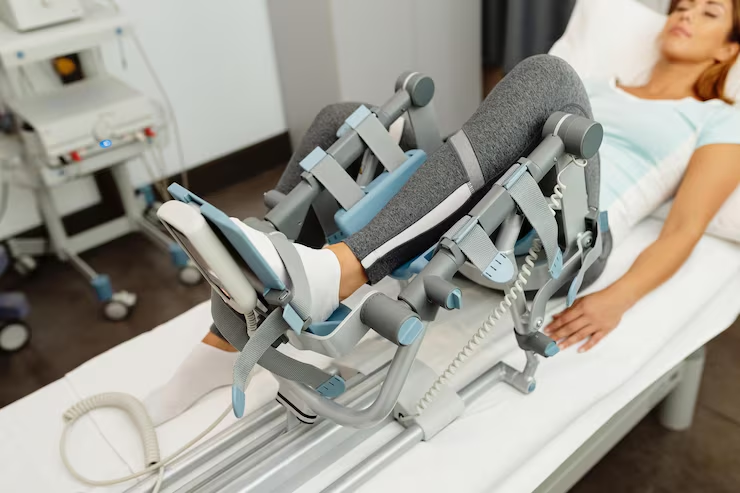 Patient using a physiotherapy leg machine